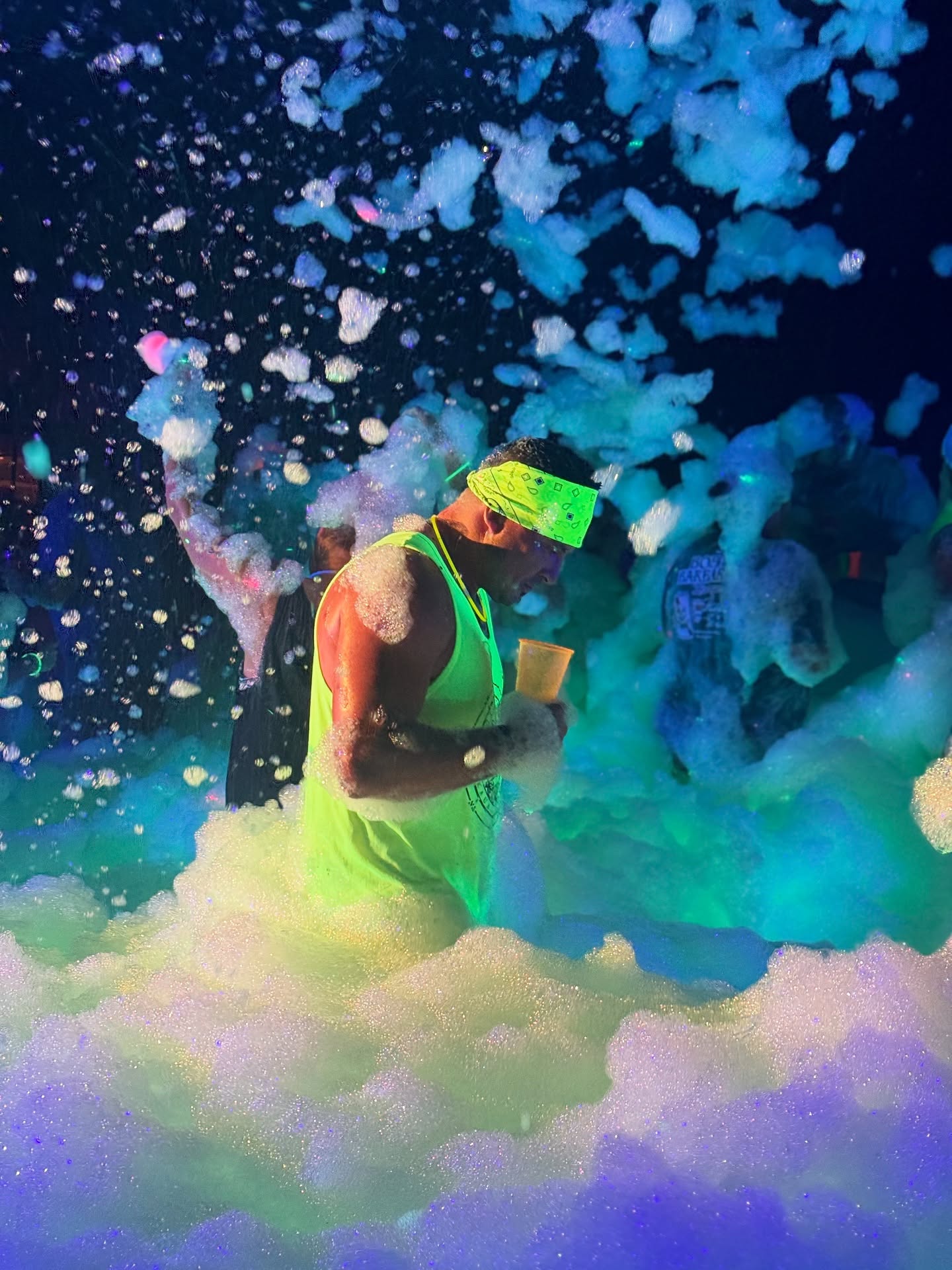 Glow foam party with neon lighting and high-energy crowd