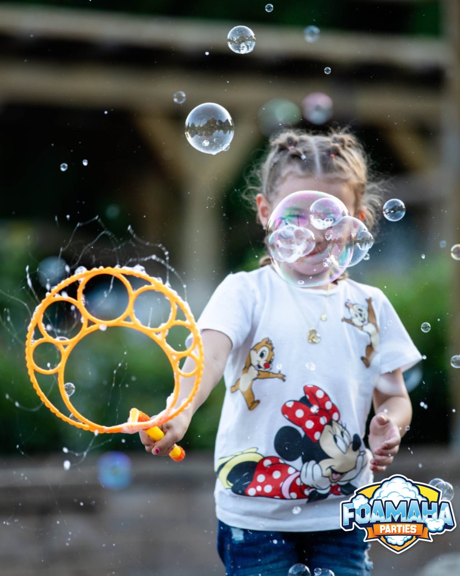 Child playing with a giant bubble wand outside