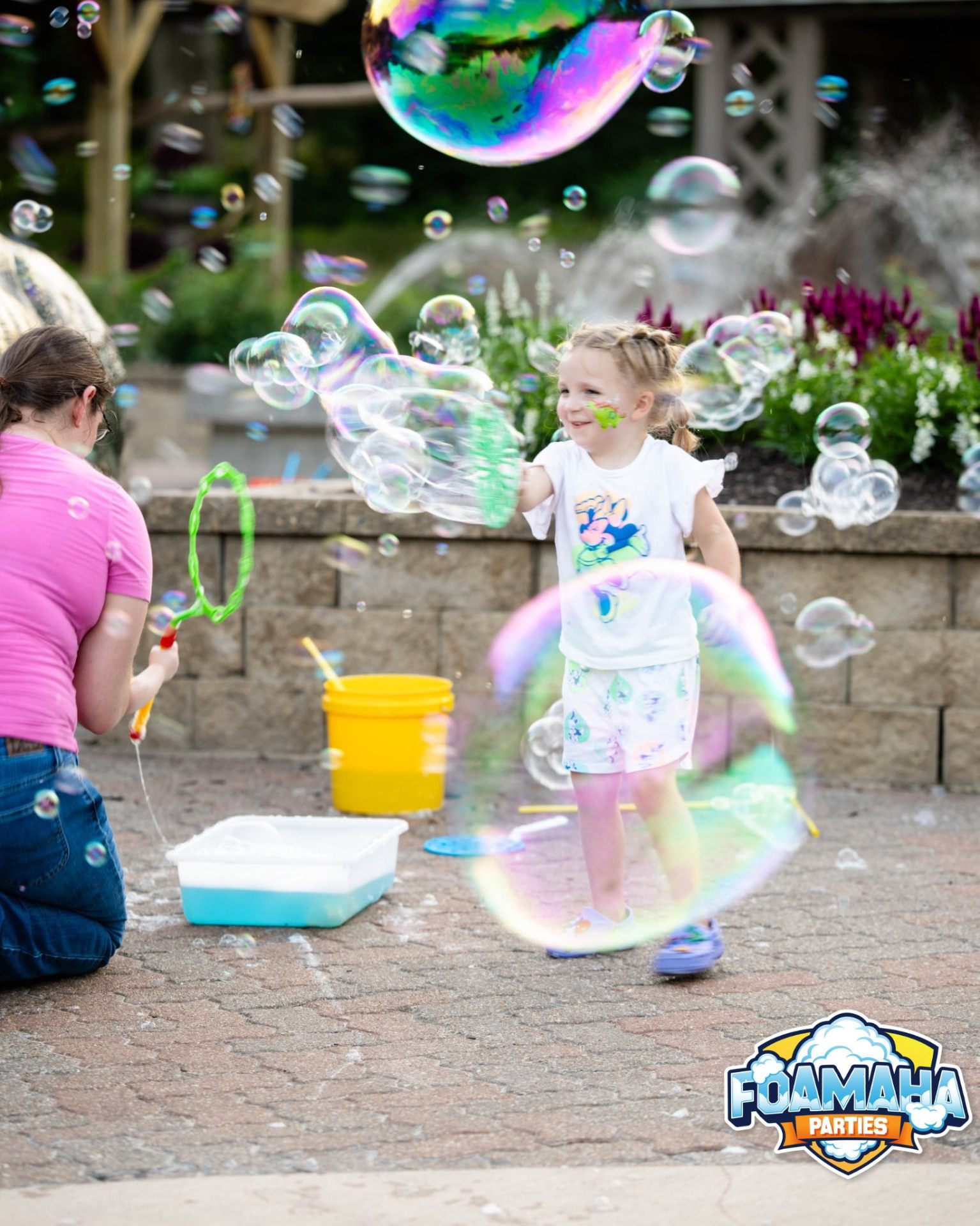 Girl playing with giant bubble wands in a garden